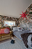 Metal bed and opulent floral wallpaper in vintage-style teenager's bedroom