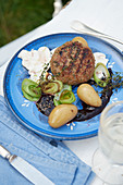 Grilled veal meatballs with blueberry sauce and marinated mushrooms