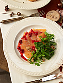 Salmon carpaccio with lambs lettuce and cranberries