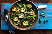 Pasta with zucchini, mushrooms, pesto and basil