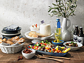 A table laid with Greek dishes