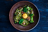 Tagliatelle with meatballs, pesto, broccoli and basil