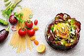 Vegetable noodle salad next to ingredients