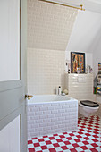 Classic bathroom with subway tiles and red-and-white chequered floor
