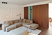 Pale sofa set next to wooden sliding doors in living room