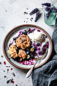 Blueberry cobbler with ice-cream in a ceramic bowl.