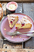 Ricotta cake with rasberries served on pink plate and wooden background.