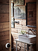 Hand basin against rustic plank wall