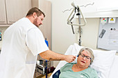 Nurse taking patient's temperature