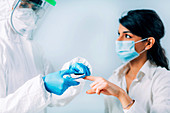 Medical worker checking blood oxygen of coronavirus patient