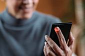 Senior woman measuring heart rate with smart phone