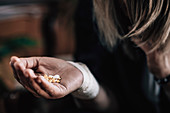Depressive suicidal woman with pills in hand