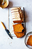 Gluten free pumpkin bread cut into slices with a knife.