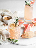 Pink grapefruit drinks with rosemary