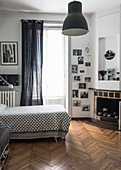 Bed with patterned bedspread, gallery of photos and fireplace in bedroom