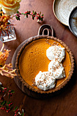Gluten free pumpkin pie with whipped cream.