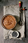 Still life with dough for brownies, vintage whisks and chocolate chips