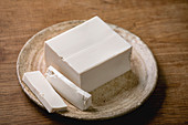 Silk tofu in one piece on a ceramic plate