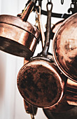 Copper pots in the kitchen on a hanging wreath