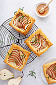 Pear and rosemary puff pastries with honey