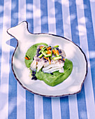 Cod in pea cream with courgettes and olives