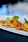 Fried scallops with sesame seeds