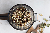 Roasted hazelnuts being puréed in a blender