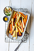 Oven-roasted root vegetables with a date and walnut dip