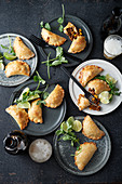 Empanadas with an onion and beef filling, limes and coriander