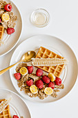 Whole graine cereal with fresh raspberries and banana, waffles and honeycombs