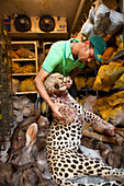 Taxidermist with leopard