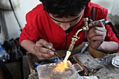 Goldsmith using blow torch