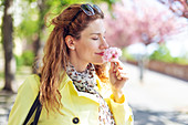 Woman smelling cherry blossom