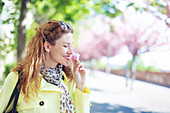 Woman smelling cherry blossom