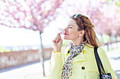 Woman smelling cherry blossom