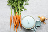 A bundle of carrots and a soup tureen