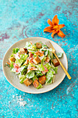 Caesar salad with lilies, wholemeal croutons and Parmesan cheese