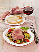 Fried duck breast with courgette, pepper and mushrooms