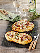Chicken pizza with dried tomatoes, onions and mozzarella