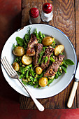 Roasted lamb on a bean salad with new potatoes