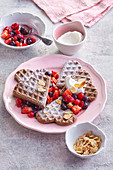 Chocolate waffles with summer berries and flaked almonds