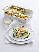 Lasagne with cheese cream, green asparagus and almonds