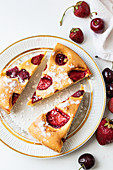 Almond cake with strawberries and cherries