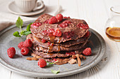 Cocoa pancakes with raspberries and maple syrup