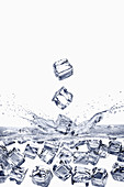 Ice cubes falling into water