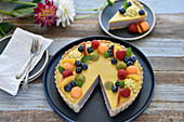Vegan tutti-frutti summer tart with peach and blueberry cream