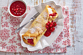 Fluffy pancakes with red berry sauce