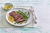 Beef steak with sauce Béarnaise and green beans