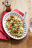 Light vegetable carbonara with courgette, carrots and bacon