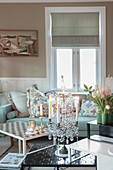 Lit candles in elegant candelabra on coffee table